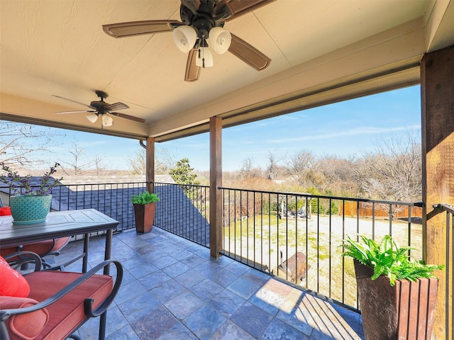 view of patio / terrace with a balcony and ceiling fan