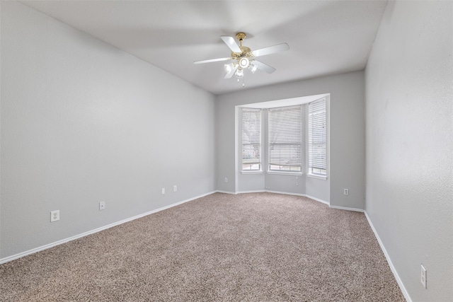 spare room with carpet floors and ceiling fan