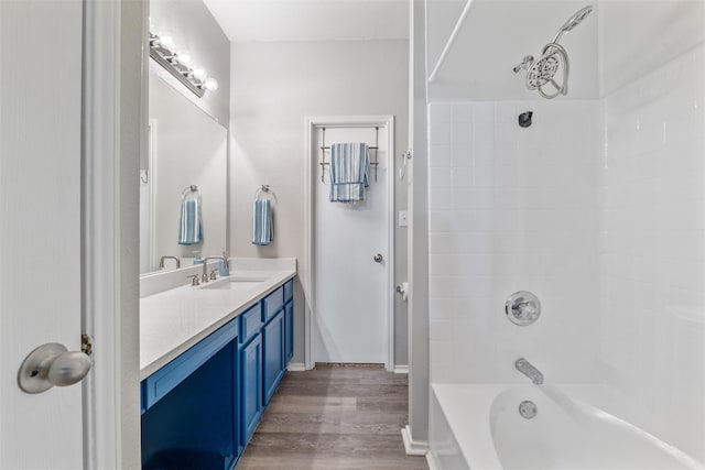 bathroom with vanity, bathing tub / shower combination, and wood-type flooring