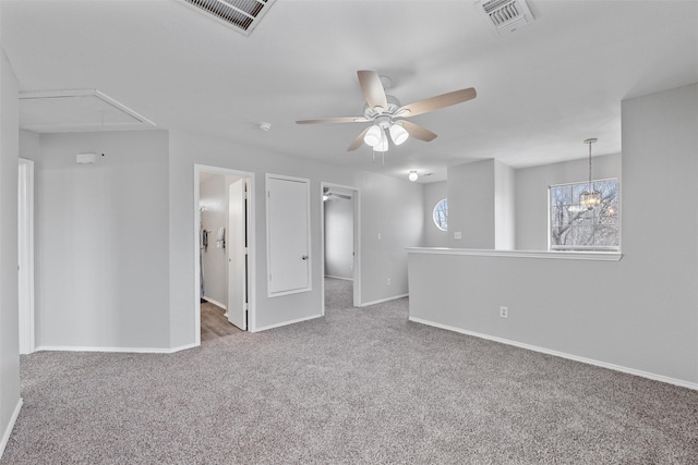 carpeted empty room with ceiling fan with notable chandelier