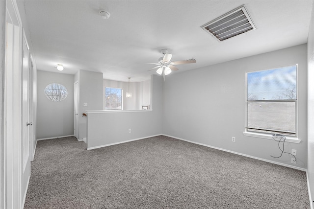 spare room with carpet and ceiling fan