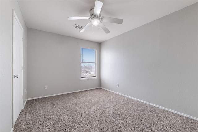 spare room featuring carpet and ceiling fan