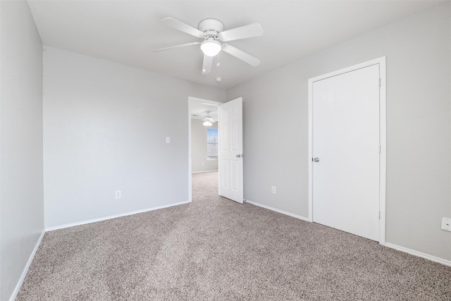 spare room with ceiling fan and carpet floors