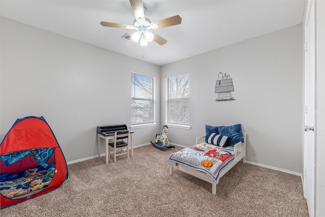 sitting room with ceiling fan and carpet