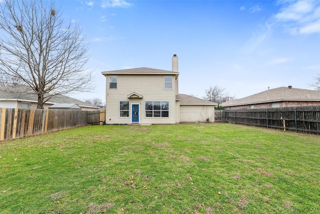 rear view of house featuring a yard