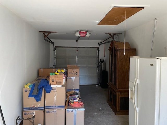 garage with a garage door opener and white fridge with ice dispenser