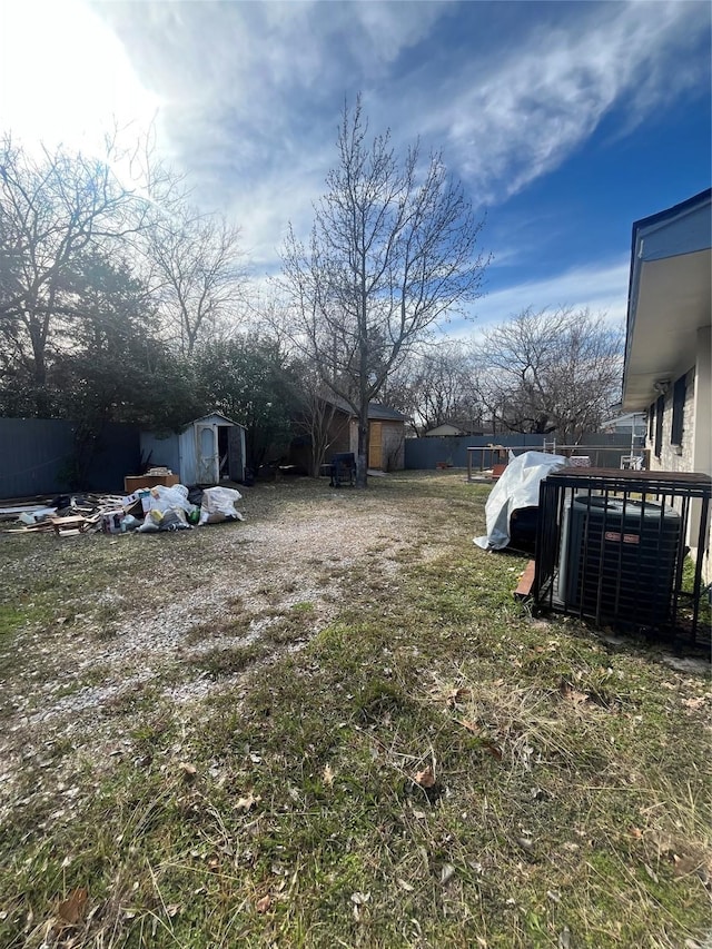 view of yard with a shed and central air condition unit