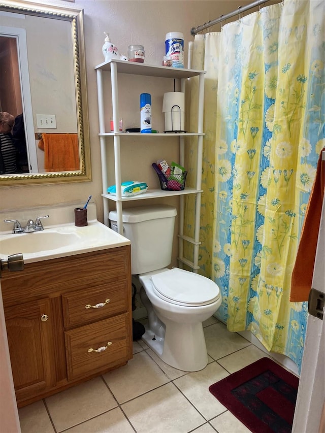 bathroom featuring tile patterned flooring, vanity, a shower with shower curtain, and toilet