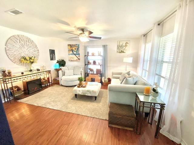 living room featuring hardwood / wood-style flooring and ceiling fan