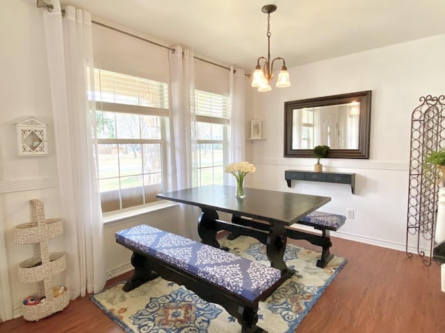 dining room featuring an inviting chandelier and dark hardwood / wood-style floors