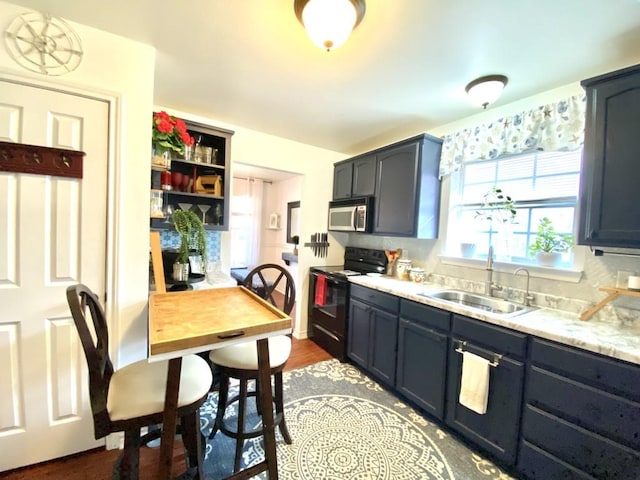 kitchen with tasteful backsplash, sink, and electric range