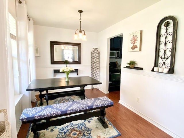 dining room featuring an inviting chandelier and hardwood / wood-style floors