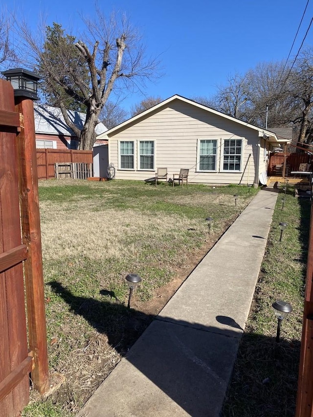 view of side of home featuring a yard