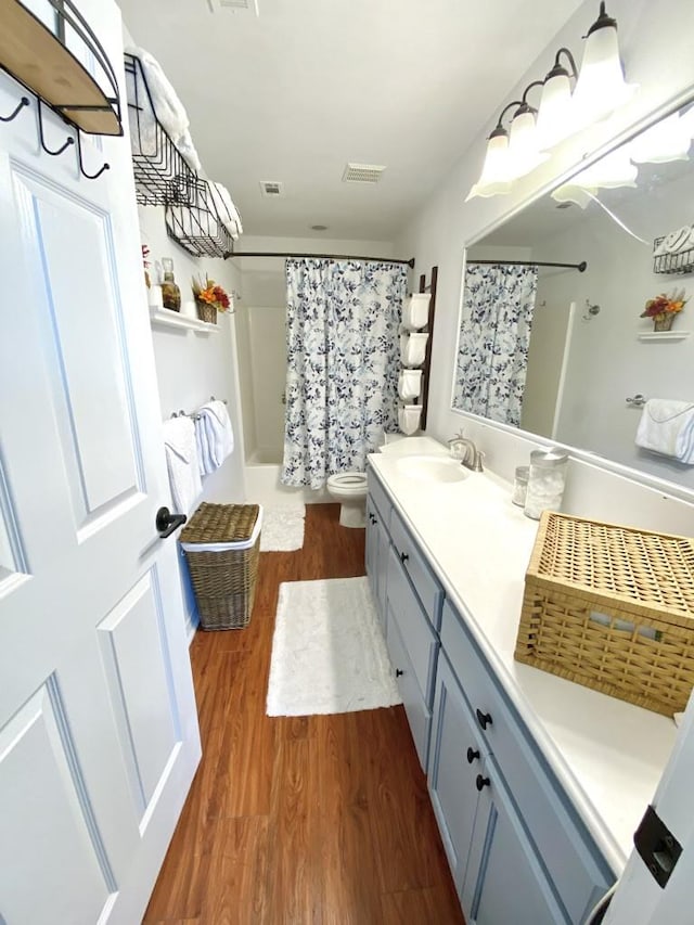 bathroom with vanity, hardwood / wood-style floors, toilet, and a shower with shower curtain