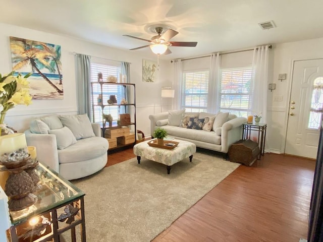 living room with ceiling fan and hardwood / wood-style floors