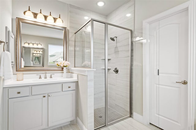 bathroom featuring vanity and an enclosed shower