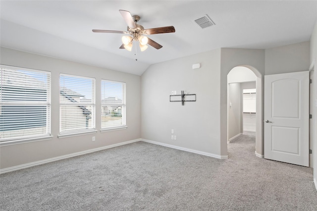 carpeted spare room with ceiling fan and lofted ceiling