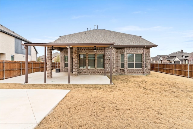 rear view of property with ceiling fan and a patio area