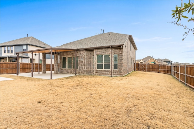 back of property featuring a patio area and a lawn