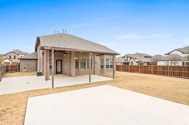 rear view of property featuring ceiling fan and a patio