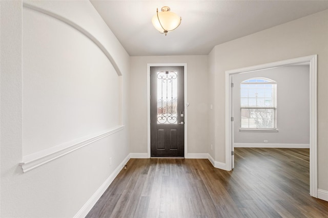 entryway with dark hardwood / wood-style flooring