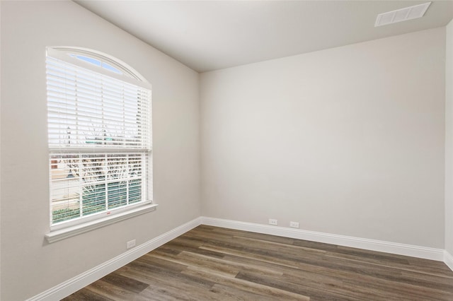 spare room featuring dark hardwood / wood-style floors