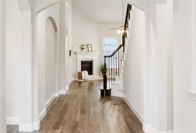 hallway with hardwood / wood-style flooring