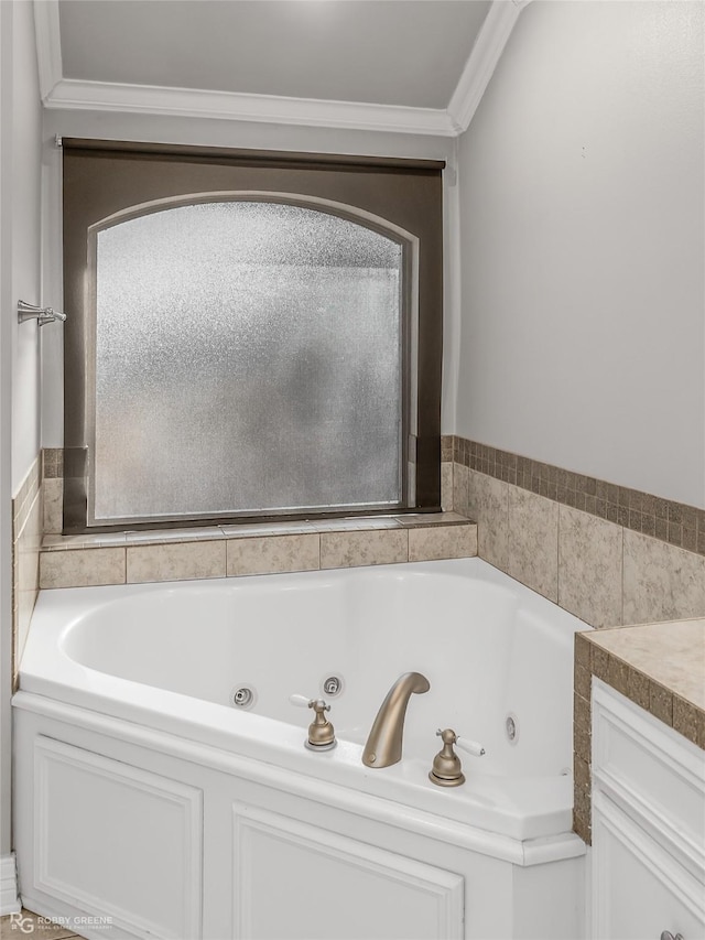 bathroom with crown molding, vanity, and a bathing tub