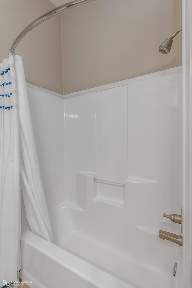 bathroom with shower / bath combo with shower curtain