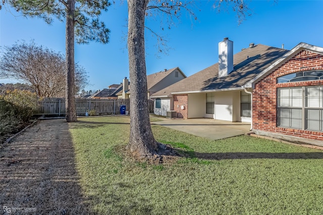 rear view of house with a patio, a yard, and cooling unit