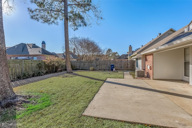 view of yard featuring central AC unit and a patio area