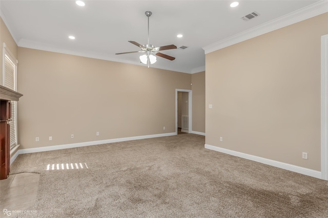 empty room with crown molding, light colored carpet, and ceiling fan