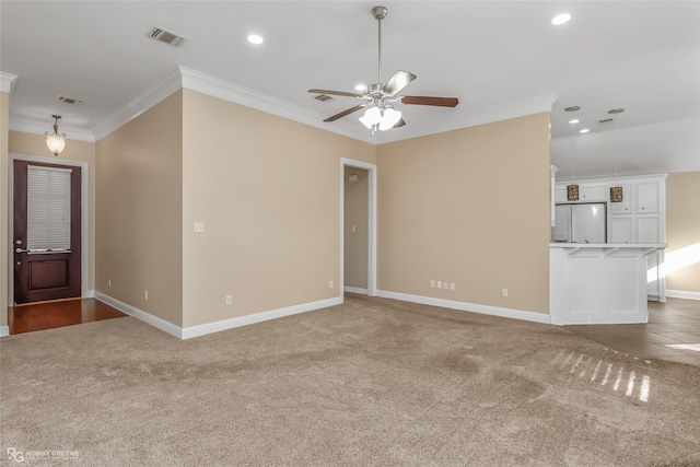 unfurnished living room with ceiling fan, ornamental molding, and dark colored carpet