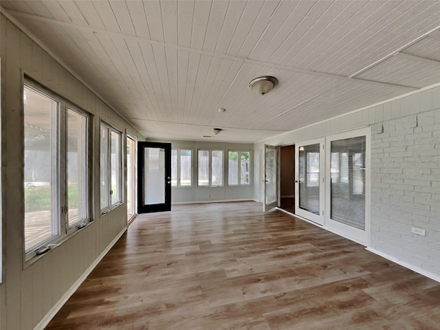 unfurnished sunroom featuring wood ceiling