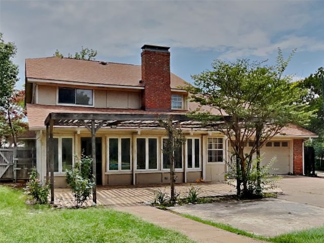 back of property featuring a pergola and a patio