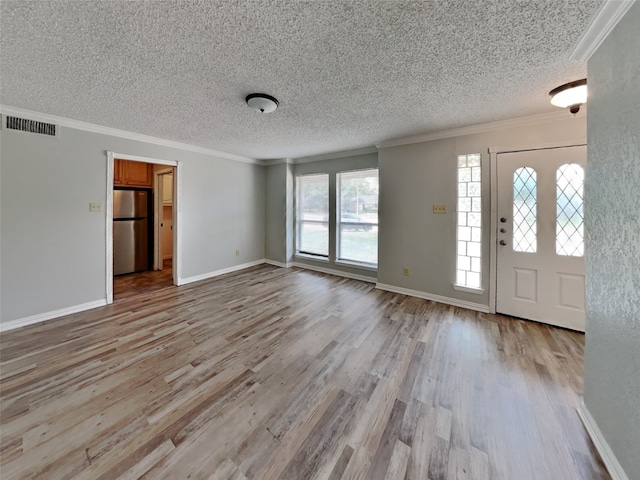 entrance foyer featuring crown molding, light hardwood / wood-style floors, and a textured ceiling