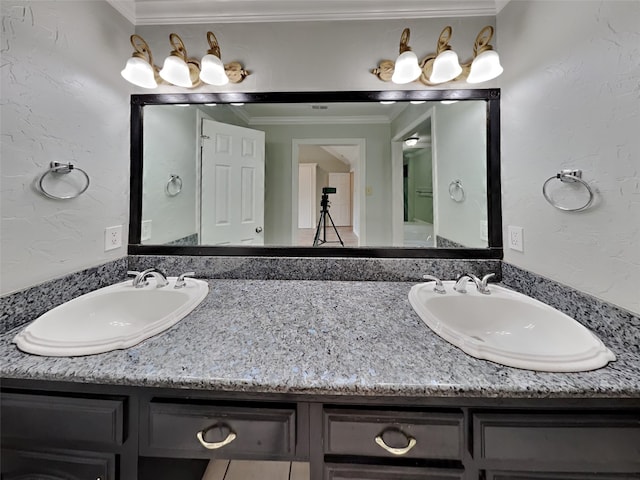 bathroom featuring crown molding and vanity