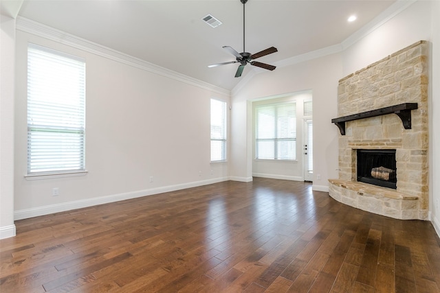 unfurnished living room featuring a stone fireplace, ornamental molding, dark hardwood / wood-style floors, and ceiling fan