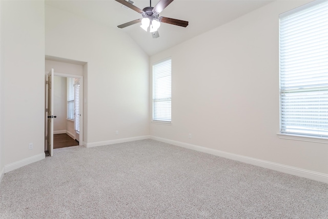 carpeted empty room featuring vaulted ceiling and ceiling fan