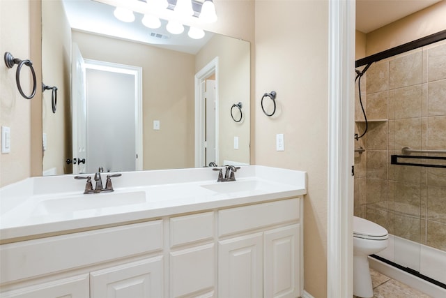 bathroom featuring vanity, tile patterned flooring, toilet, and walk in shower