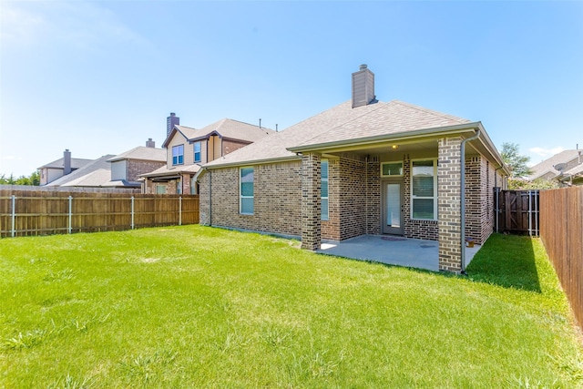 back of house with a yard and a patio area