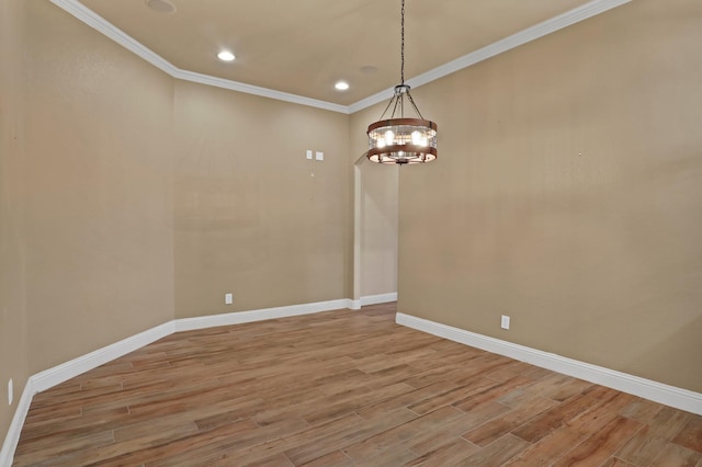 unfurnished room with ornamental molding, light hardwood / wood-style floors, and a chandelier