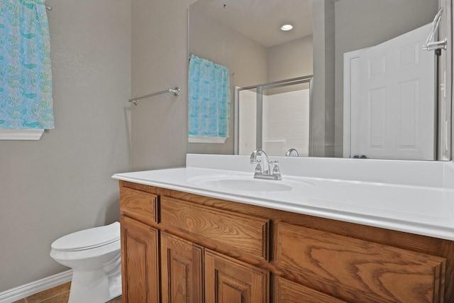 bathroom with vanity, toilet, and a shower with shower door