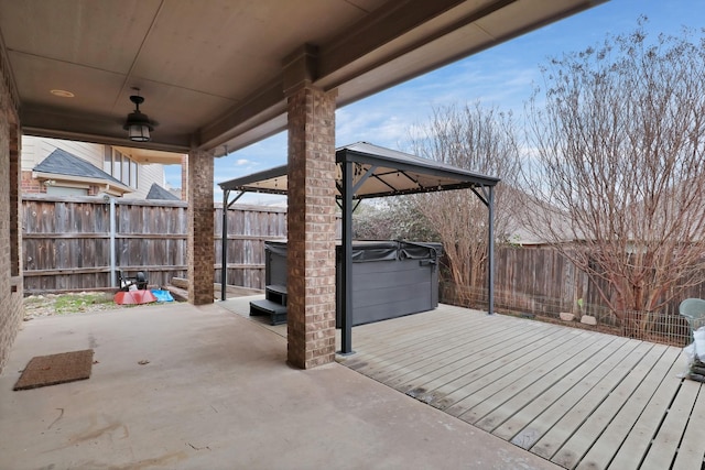 view of patio with a wooden deck, a gazebo, and a hot tub