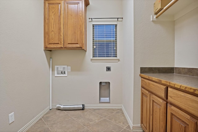 laundry room with electric dryer hookup, light tile patterned floors, washer hookup, and cabinets