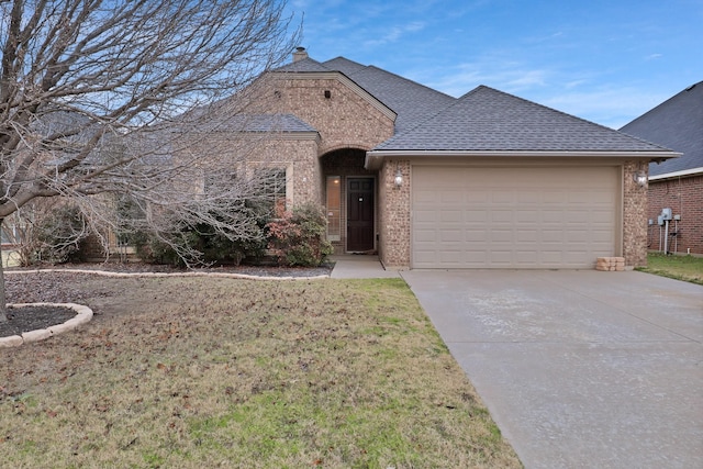 view of front of house with a garage and a front yard