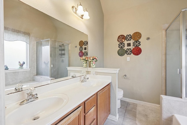 full bathroom featuring toilet, vanity, shower with separate bathtub, and tile patterned flooring