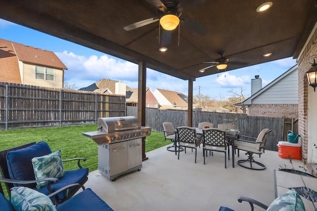 view of patio with ceiling fan and grilling area