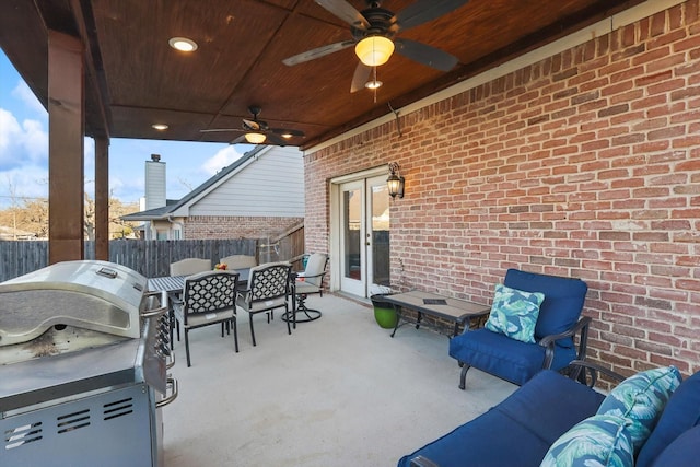 view of patio with ceiling fan, grilling area, and french doors