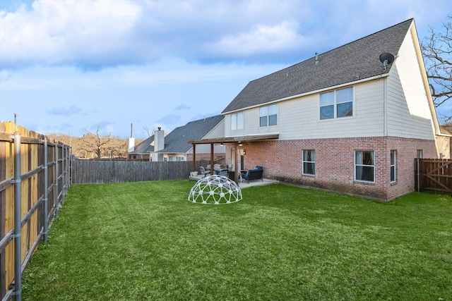 rear view of house with a lawn and a patio